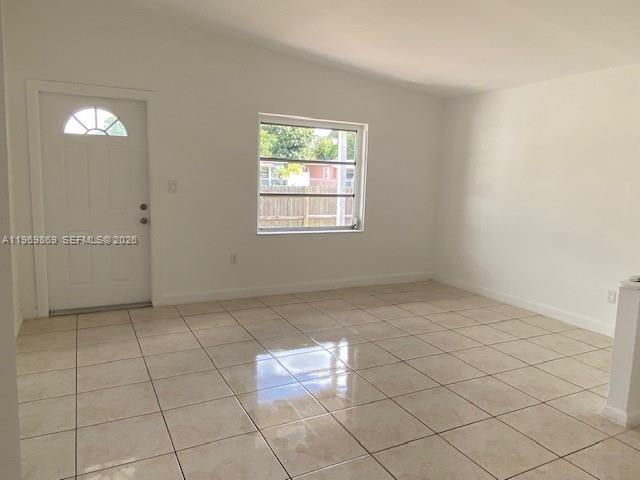 An empty room features white walls, a single window, and light-colored tiled flooring — 540 Opa Locka Blvd, North Miami FL 33168, NORTH MIAMI, FL