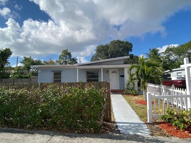 A single-story house with a light blue exterior, a white front door, and a white fence — 540 Opa Locka Blvd, North Miami FL 33168, NORTH MIAMI, FL