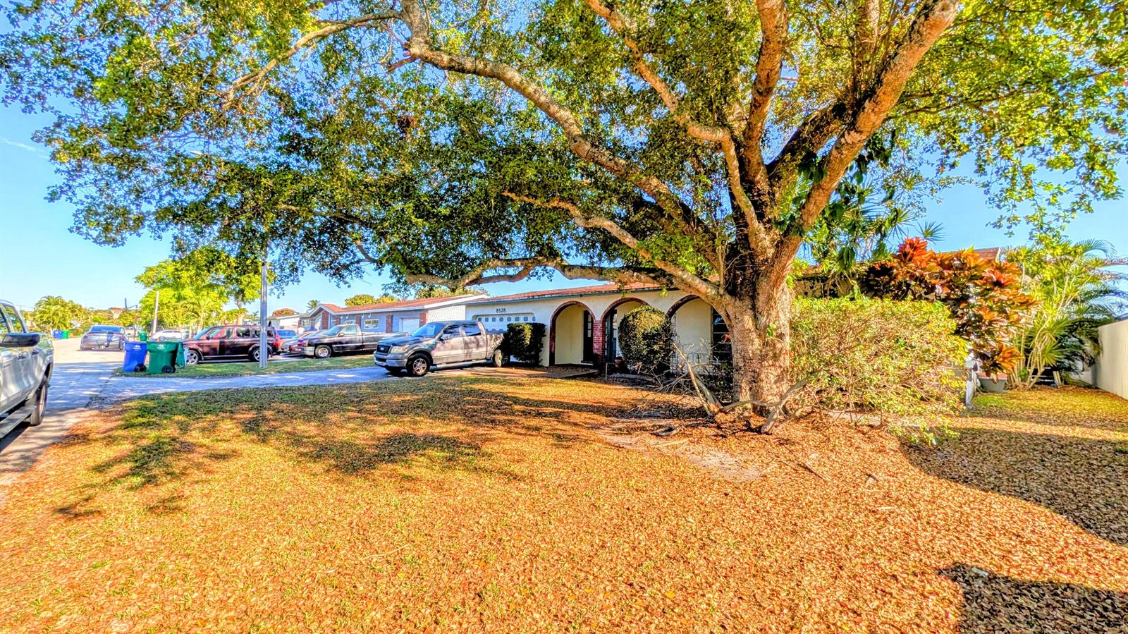 A single-story house with a large tree in the front yard and parked vehicles — 8528 Windsor Drive, Miramar FL 33025, MIRAMAR, FL