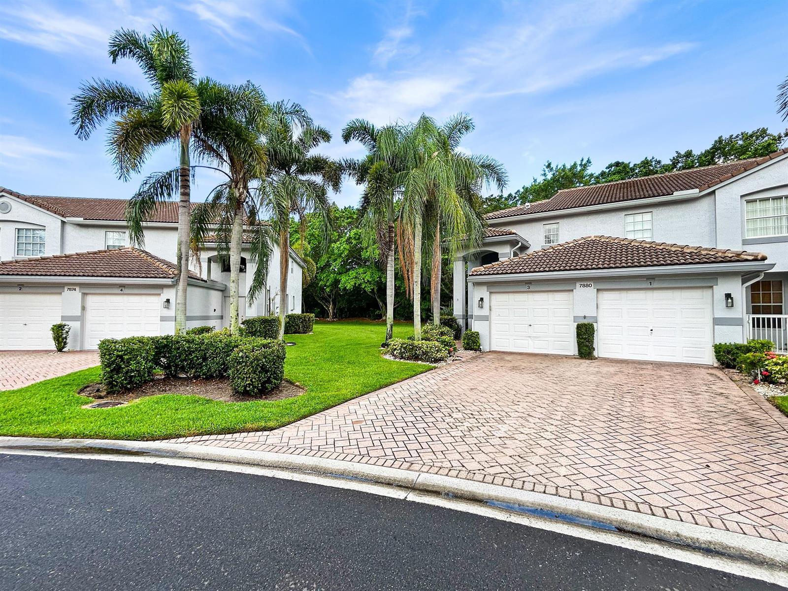 Two multi-unit residential buildings with paved driveways and palm trees on a grassy lawn — 7880 Laina Lane # 3, Boynton Beach FL 33437, BOYNTON BEACH, FL