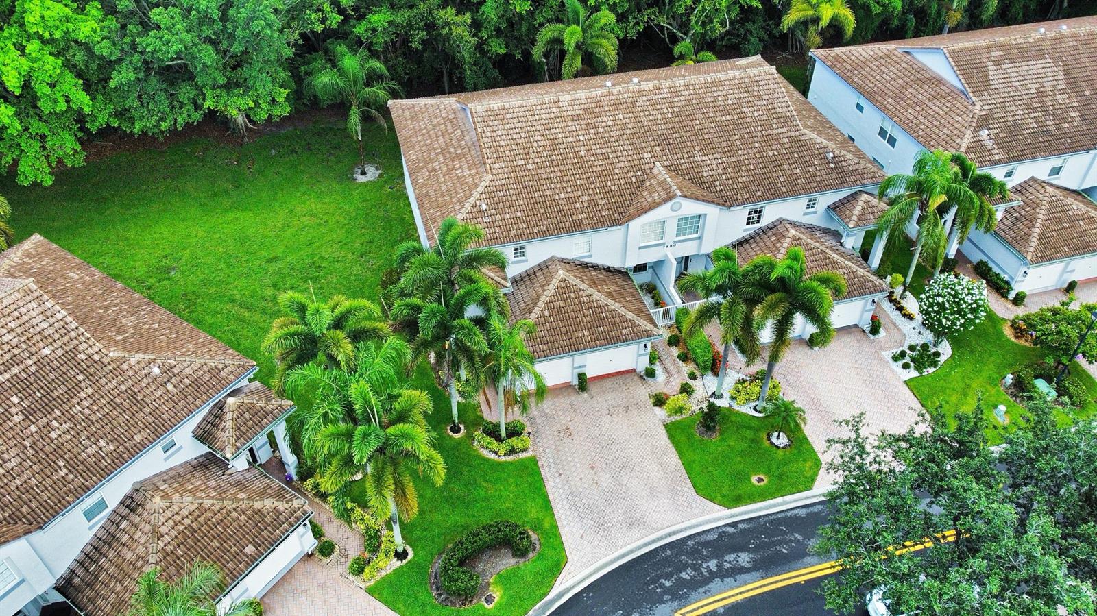 An aerial view shows two multi-story residential buildings with brown tile roofs and paved driveways — 7880 Laina Lane # 3, Boynton Beach FL 33437, BOYNTON BEACH, FL