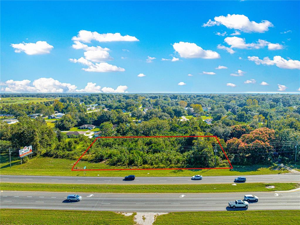 An aerial view shows a rectangular plot of land outlined in red beside a highway — 0 N US HWY 441, OCALA, FL