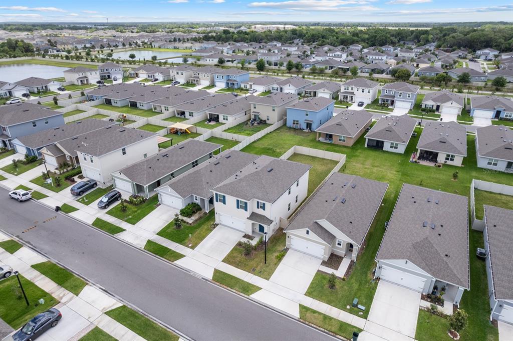 An aerial view shows a suburban neighborhood with multiple single-family homes and paved streets — 3524 SUNGROVE CIRCLE, SANFORD, FL