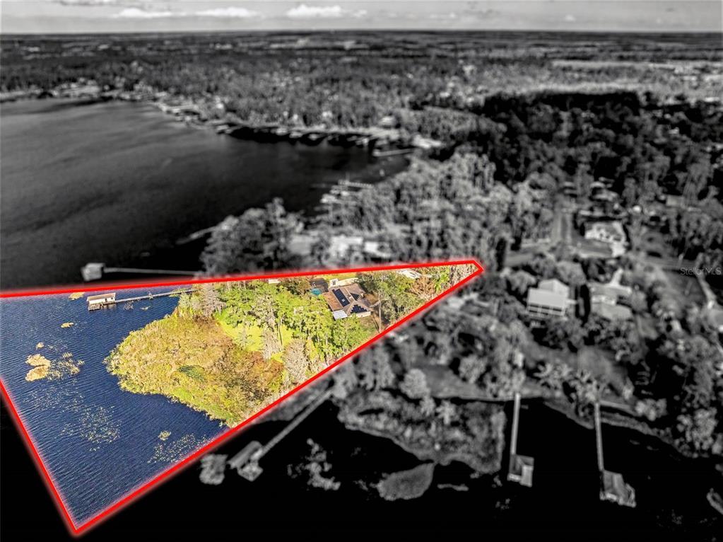 An aerial view shows a waterfront property highlighted by a red triangular outline — 14051 MARINE COURT, ORLANDO, FL