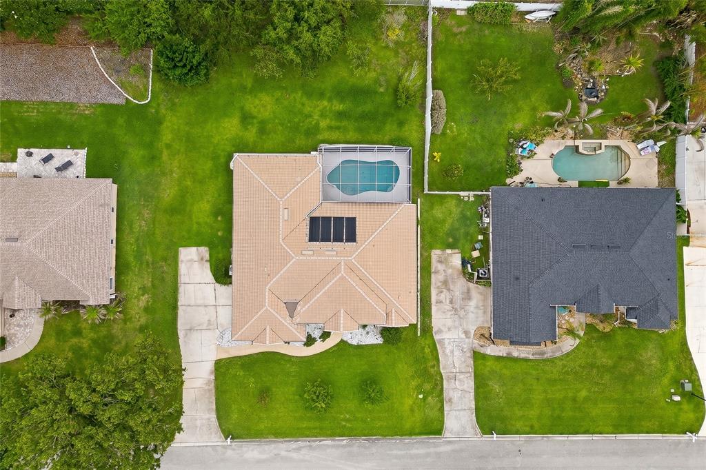 An aerial view shows three suburban houses with pools, driveways, and green lawns — 10708 BELO HORIZONTE AVENUE, CLERMONT, FL