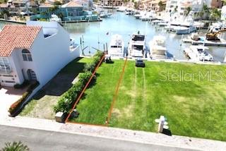An aerial view shows a vacant waterfront lot outlined in red next to a house — 1 SAN MIGUEL ISLAND UNIT 6, HUMACAO, PR