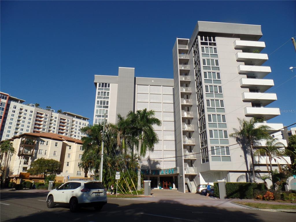 A multi-story apartment building with a white facade, balconies, and palm trees in front — 470 3RD STREET S UNIT 616, ST PETERSBURG, FL