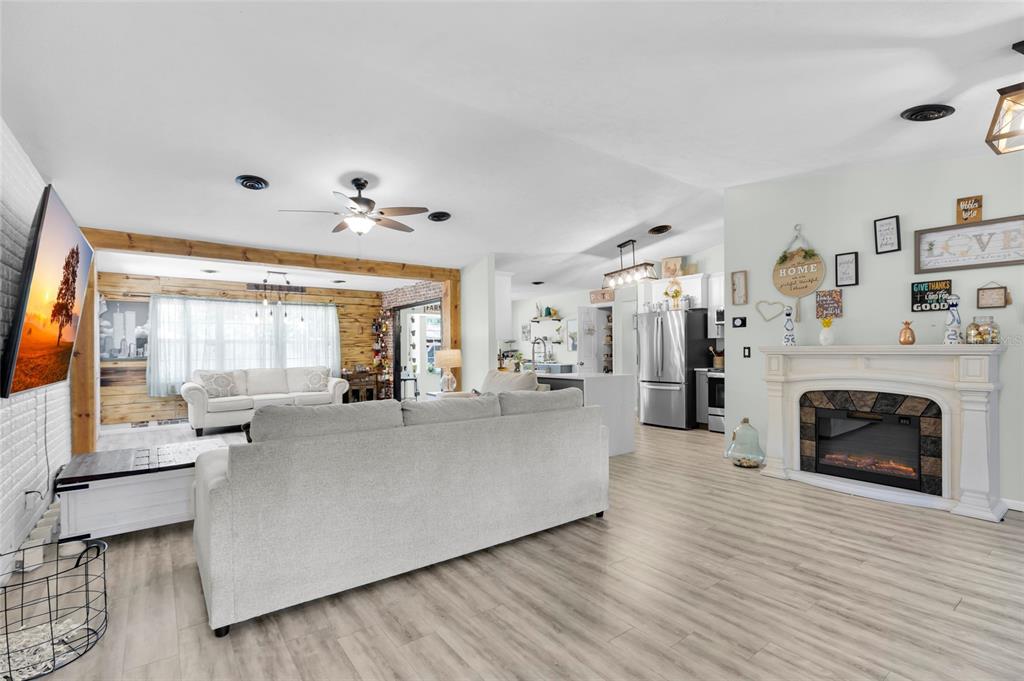 A kitchen with white cabinets, stainless steel appliances, and a dining area with bay windows — 4630 SE 58TH PLACE, OCALA, FL