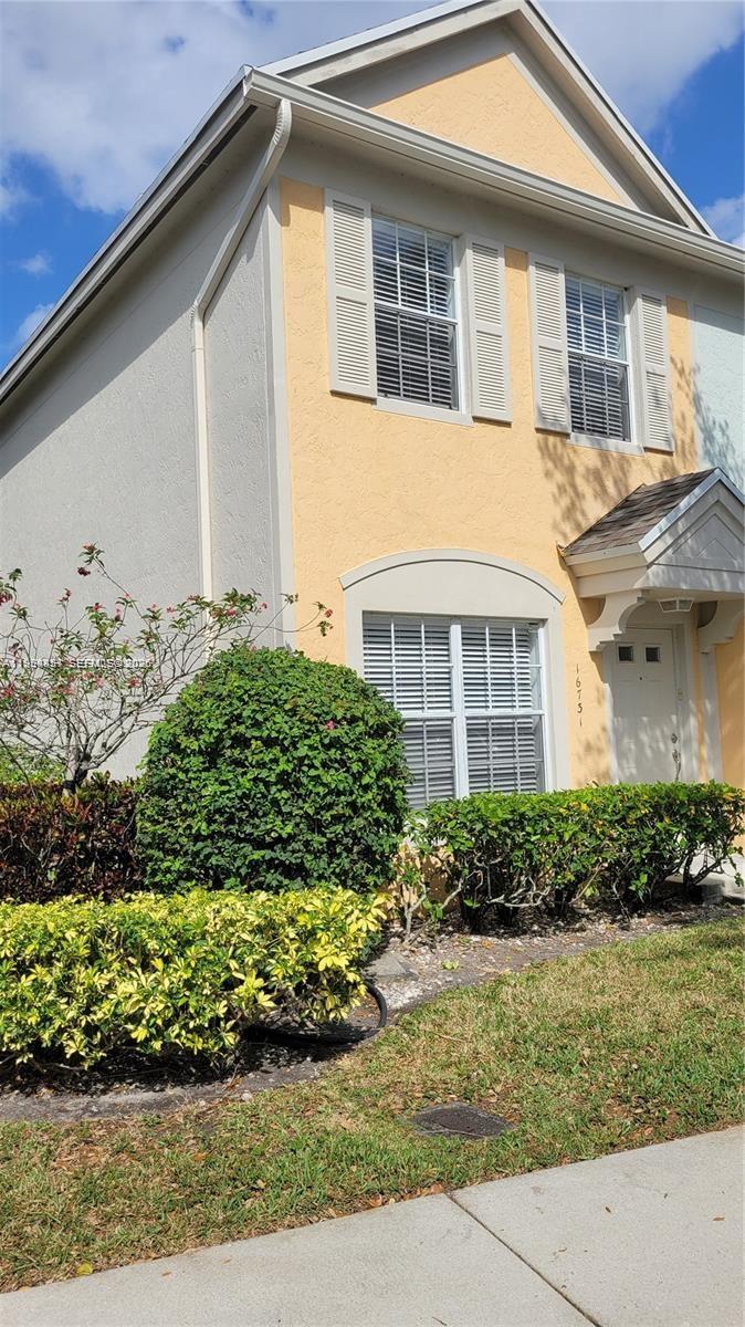 A room with white tiled floors, a pass-through window to the kitchen, and a door — 16731 Hemingway Dr, Weston FL 33326, WESTON, FL