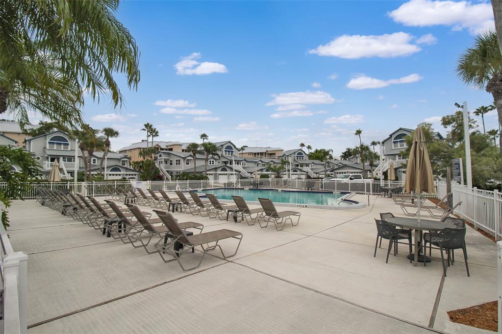 A swimming pool surrounded by lounge chairs and a dining set on a concrete deck — 1339 SIESTA BAYSIDE DRIVE UNIT 1339-C, SARASOTA, FL