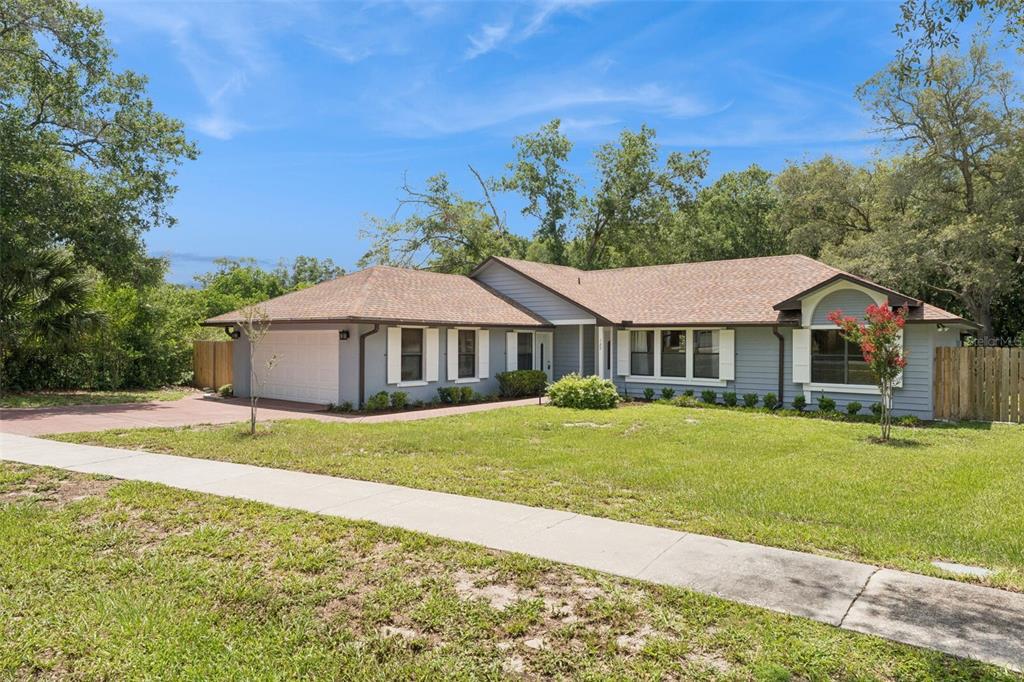 A single-story house with gray siding, a brown roof, and a two-car garage — 125 DONNA CIRCLE, SANFORD, FL