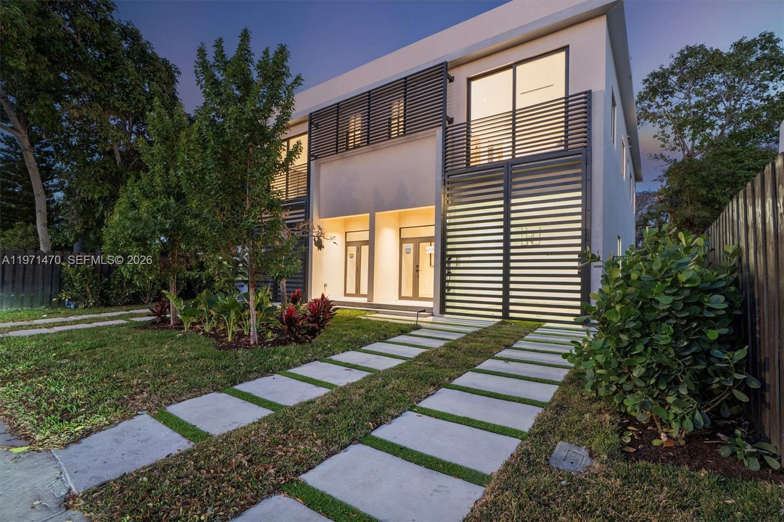 A modern two-story house features a slatted metal facade and a concrete paver driveway — 4715 N Miami Ave, Miami FL 33127, MIAMI, FL