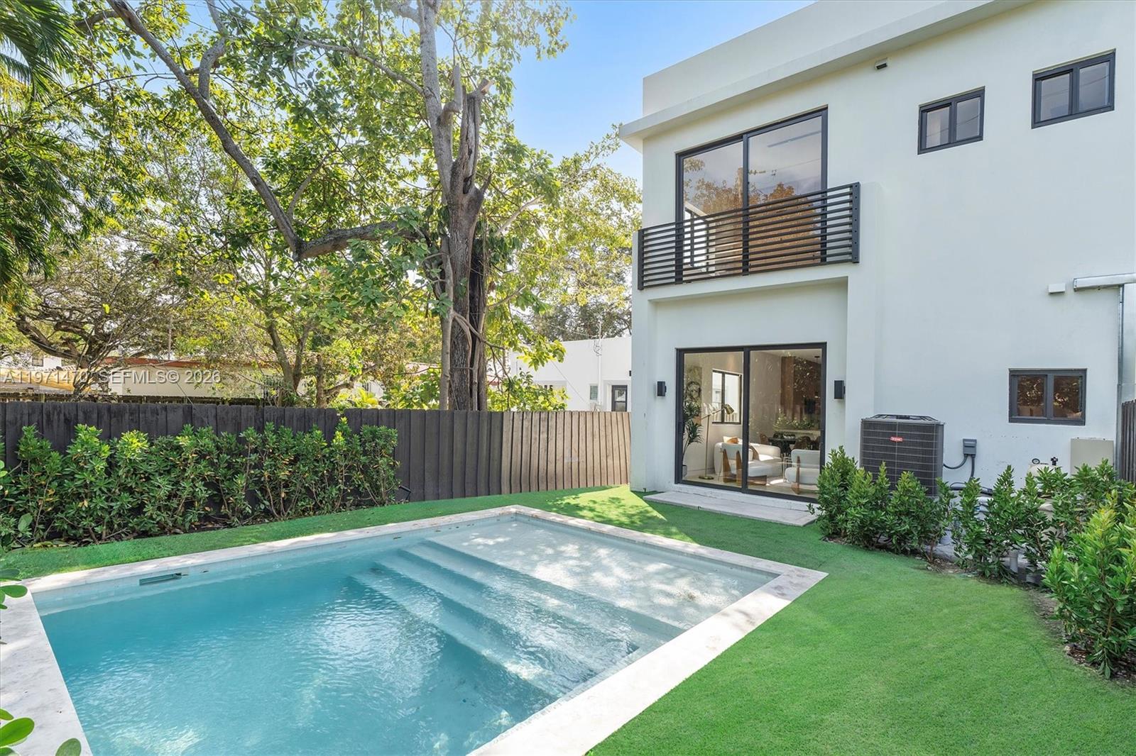 A modern two-story house features a backyard swimming pool and a second-floor balcony — 4715 N Miami Ave, Miami FL 33127, MIAMI, FL
