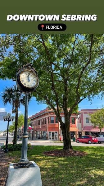 A street clock stands in a park with a historic building in the background — 1009 ORANGE CREEK LN, Sebring FL 33870, SEBRING, FL