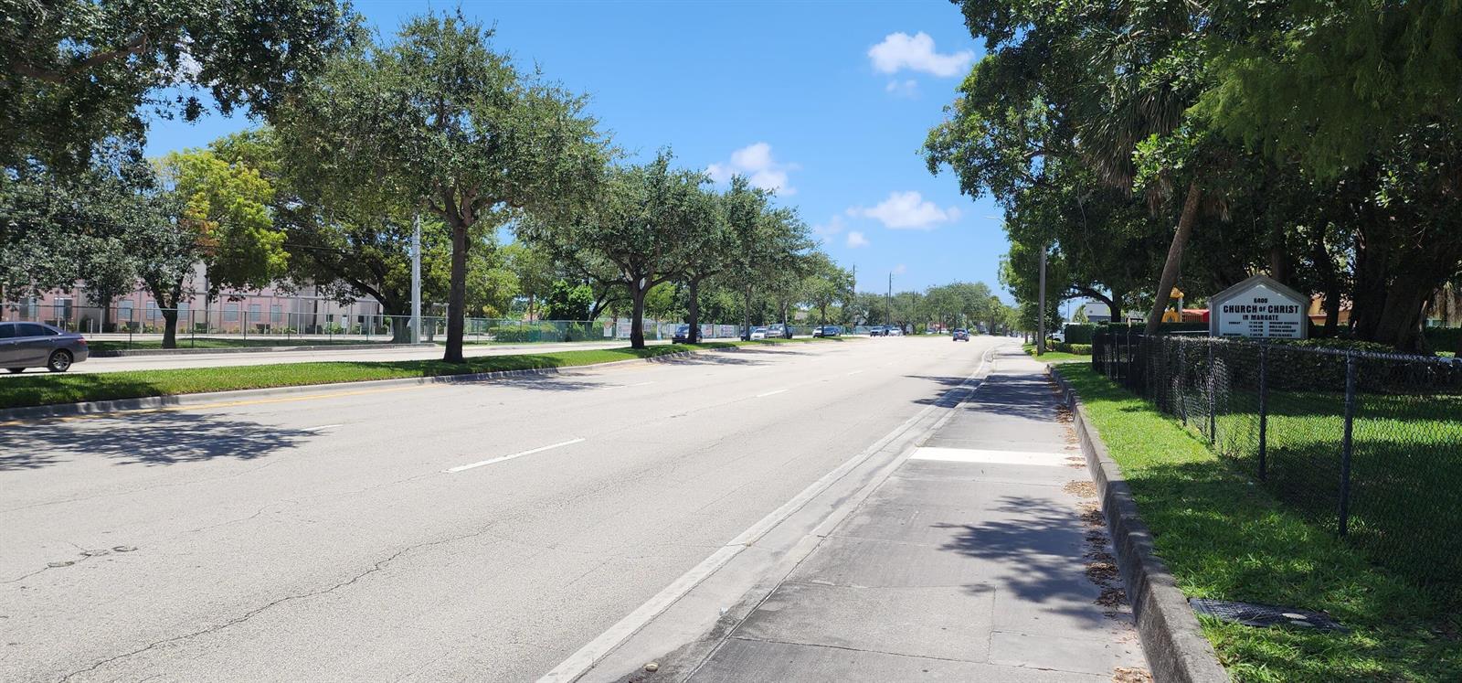 A street view showing a multi-lane road, sidewalk, trees, and a Church of Christ sign — 430 NW 65th Terrace, Margate FL 33063, MARGATE, FL