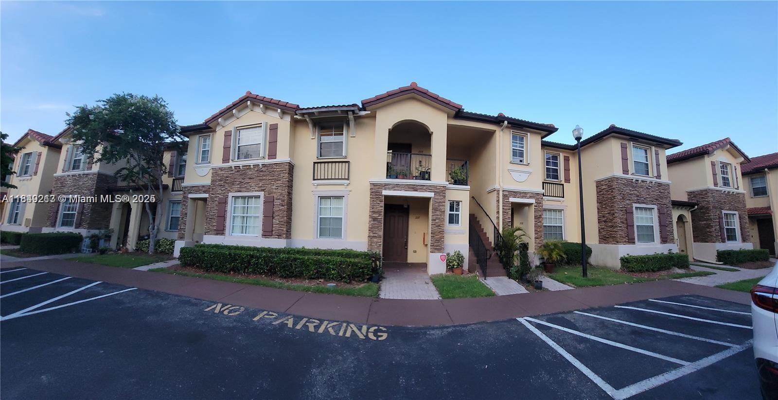A multi-story apartment building with stucco walls, stone accents, and a tile roof — 1655 NE 33rd Rd # 4, Homestead FL 33033, HOMESTEAD, FL