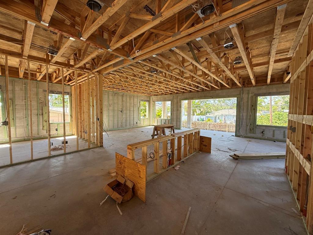 An interior view of a house under construction with exposed wooden framing and concrete walls — 4703 W FAIR OAKS AVENUE, TAMPA, FL