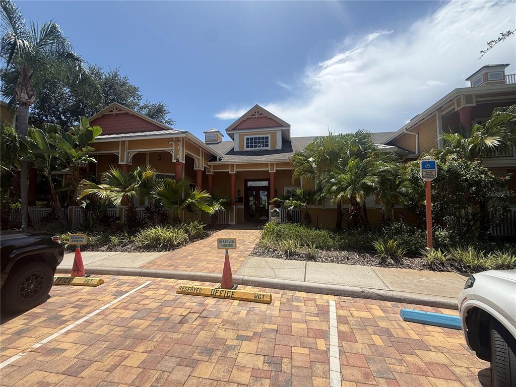 The exterior of a multi-story building features a paved parking area with reserved office spaces — 4207 S DALE MABRY HIGHWAY UNIT 2414, TAMPA, FL
