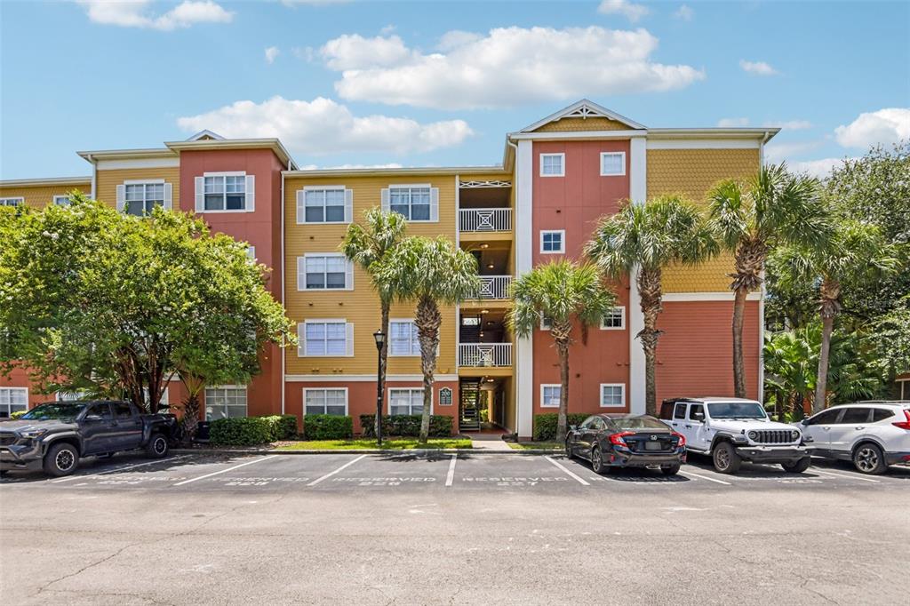 A multi-story apartment building with a parking lot in front and palm trees — 4207 S DALE MABRY HIGHWAY UNIT 2414, TAMPA, FL