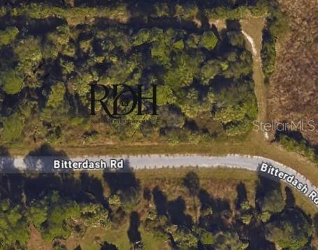 This aerial map shows a wooded lot located along a curved dirt road — BITTERBUSH ROAD, NORTH PORT, FL