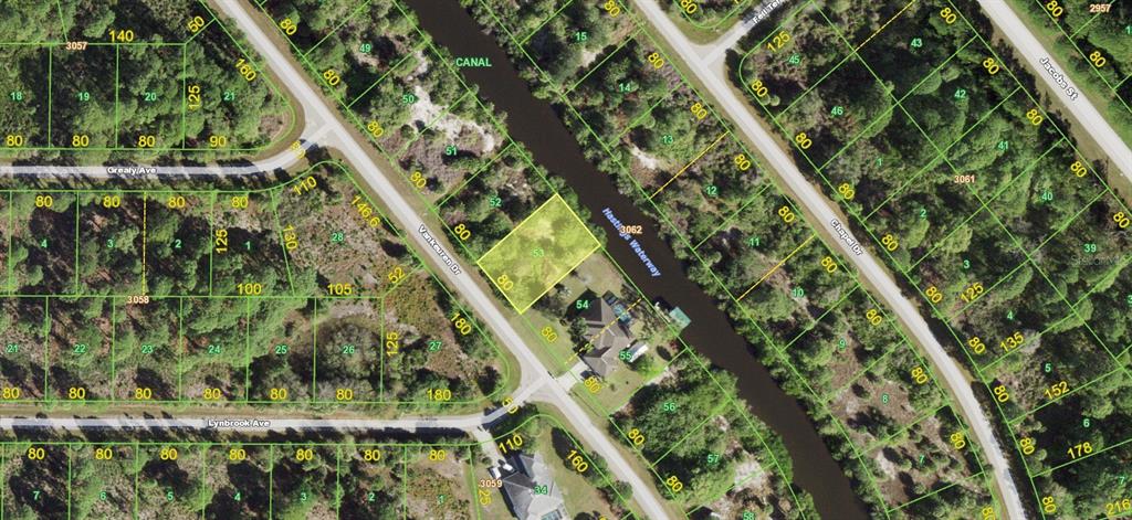 This is an aerial map showing a vacant lot highlighted in yellow along a canal — 2486 VANKEUREN DRIVE, PORT CHARLOTTE, FL