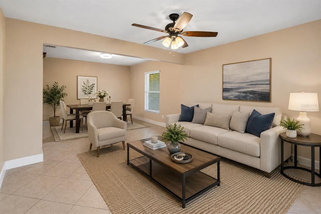 A living room and dining area with beige walls, tile floors, and a ceiling fan — 3244 HUNTER COURT, APOPKA, FL