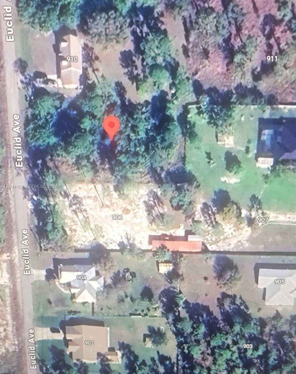 This is an aerial map view showing a vacant lot marked with a red pin — 908 E EUCLID AVE, Lehigh Acres FL 33972, LEHIGH ACRES, FL