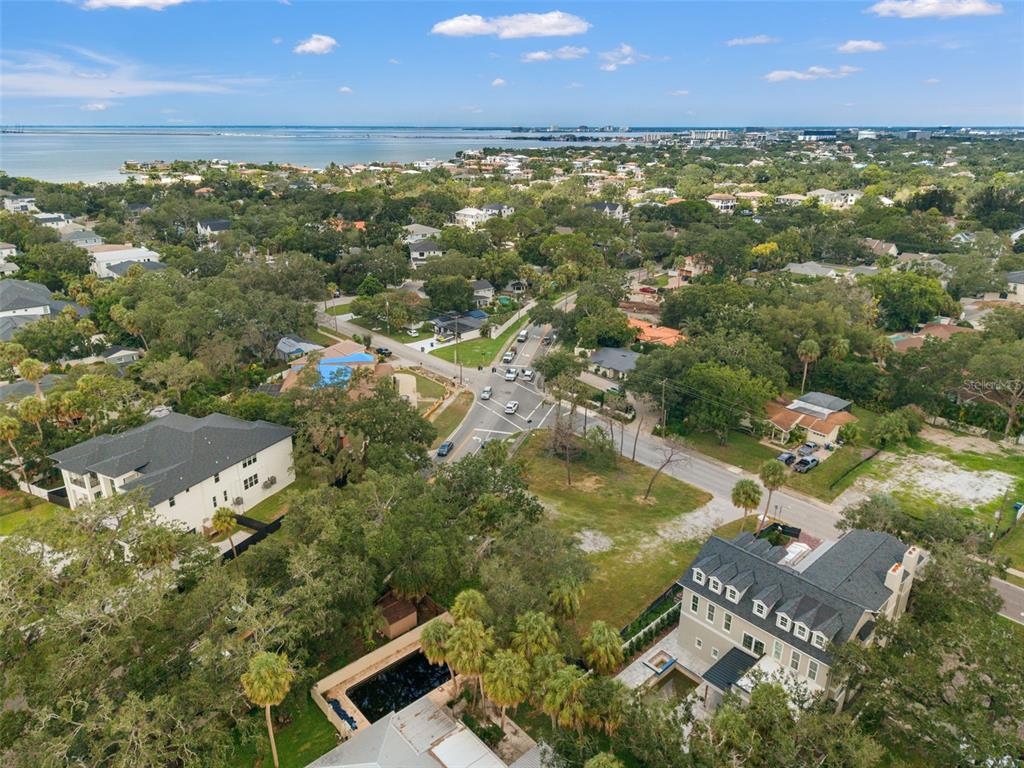 An aerial view shows a residential neighborhood with large houses, a swimming pool, and trees — 2502 S WEST SHORE BOULEVARD, TAMPA, FL