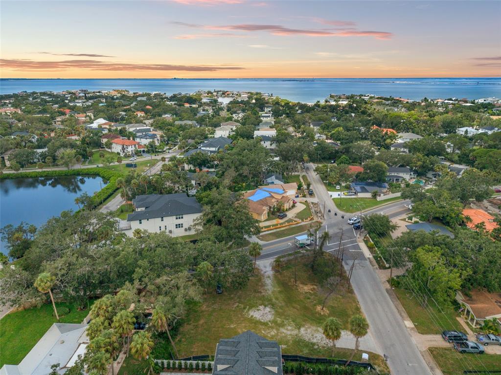 An aerial view shows a residential neighborhood near a body of water at sunset — 2502 S WEST SHORE BOULEVARD, TAMPA, FL