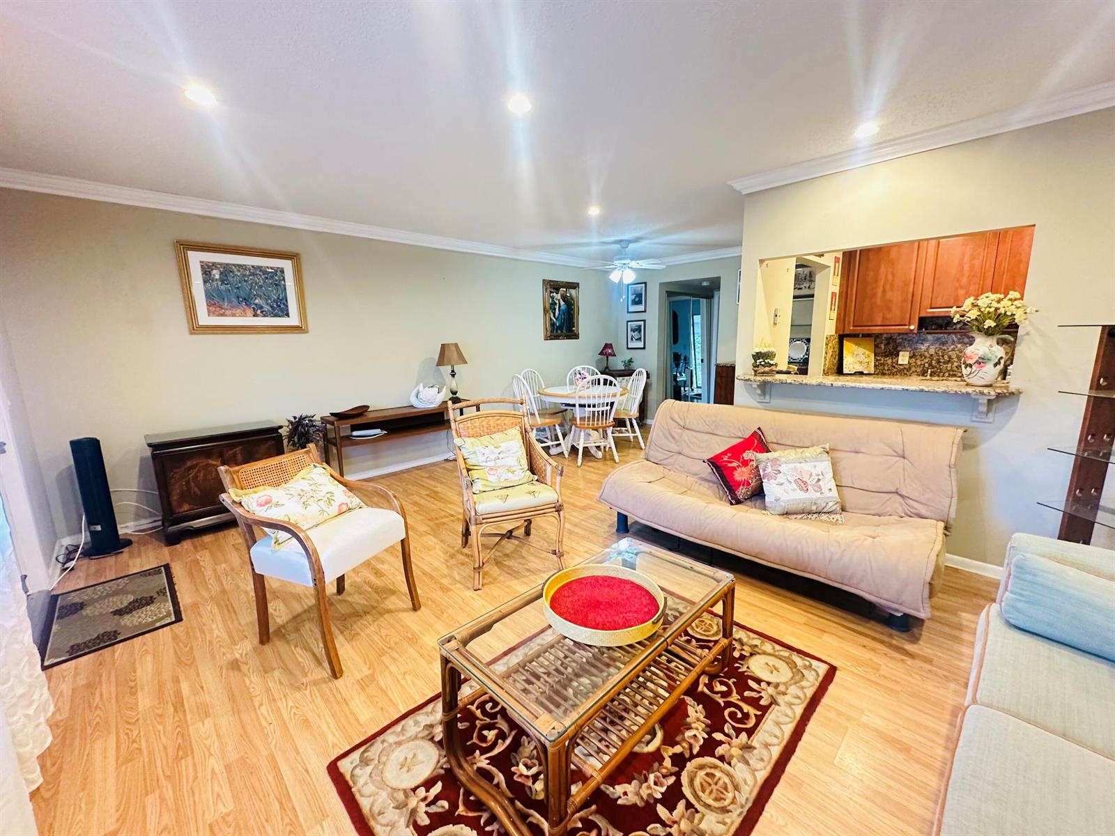 A living room with light wood flooring, a beige futon, and a glass-topped coffee table — 238 Newport O # 238, Deerfield Beach FL 33442, DEERFIELD BEACH, FL