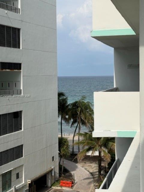 A view of the ocean and beach from between two white apartment building balconies — 3725 S Ocean Dr # 615, Hollywood FL 33019, HOLLYWOOD, FL