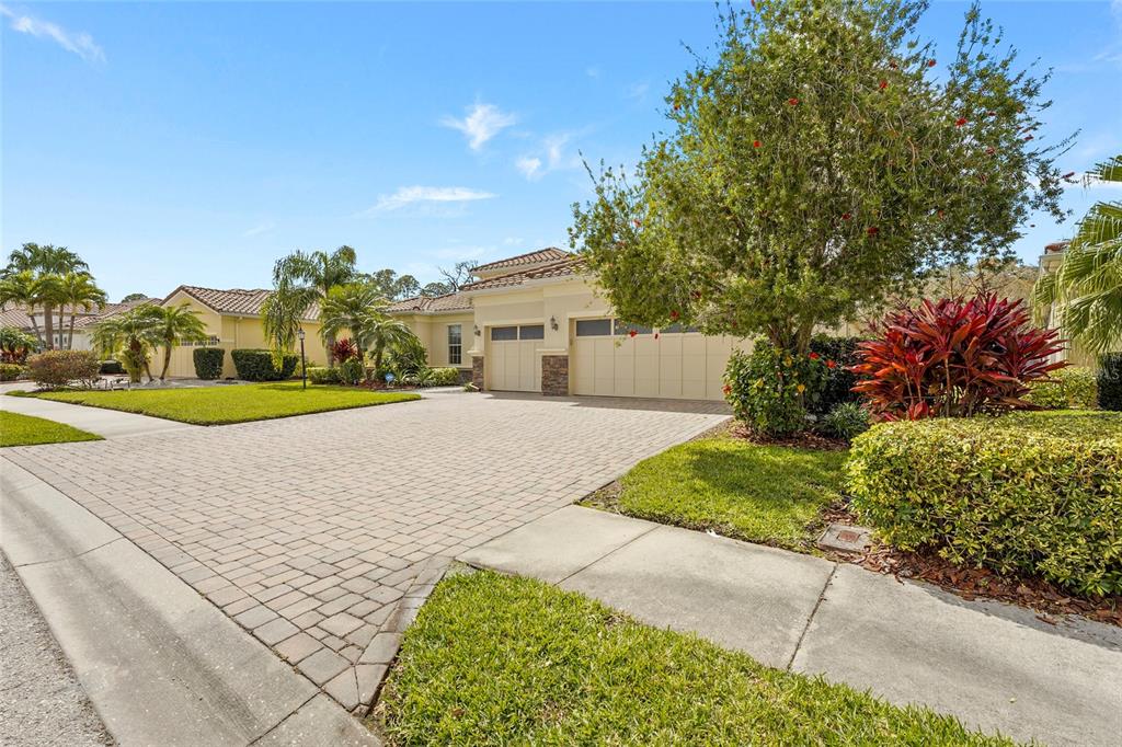 A single-story house with a paved driveway, a two-car garage, and landscaped front yard — 5750 ROCK DOVE DRIVE, SARASOTA, FL