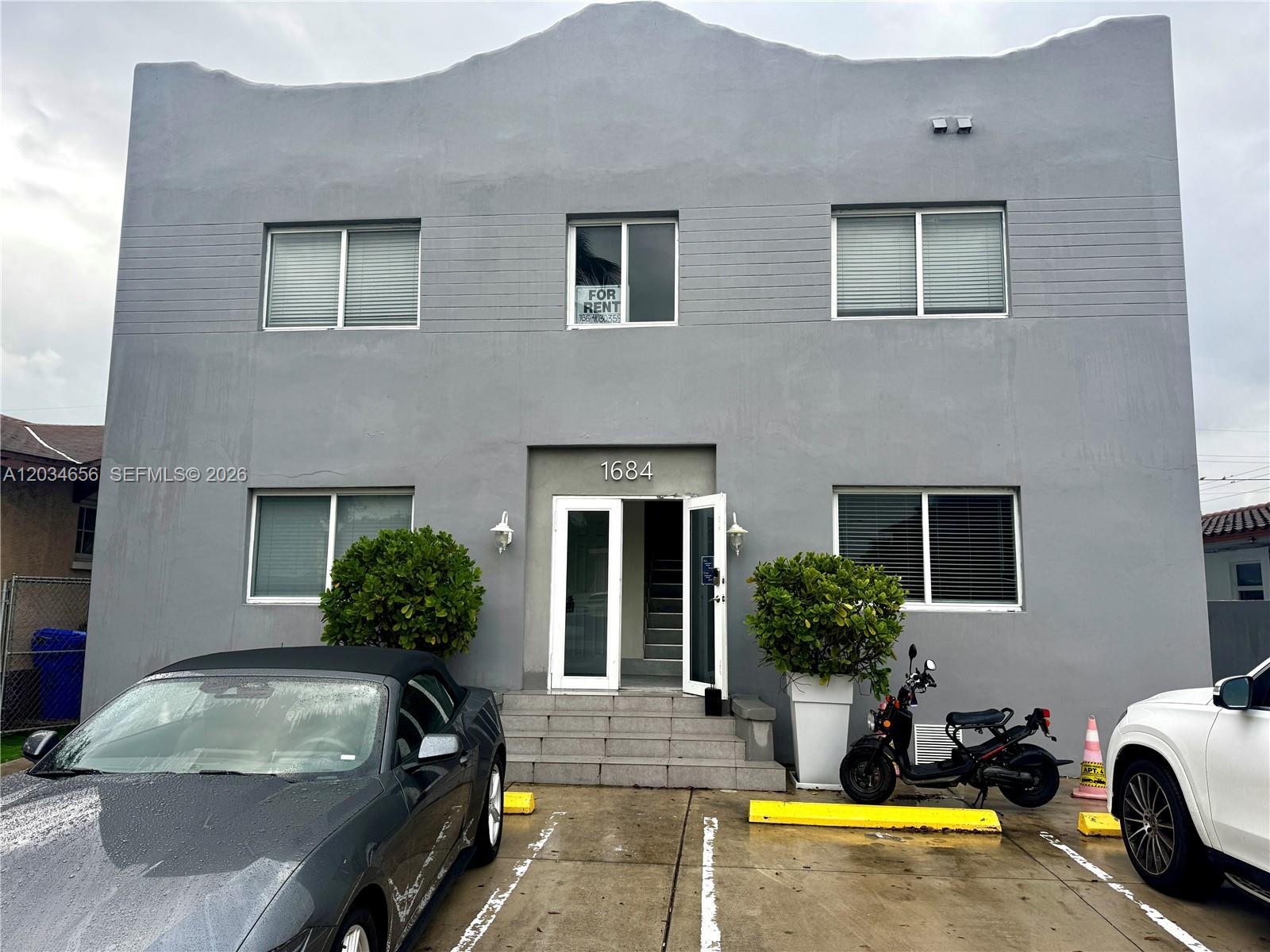A two-story gray building features a central entrance with stairs and a for-rent sign — 1684 SW 10th St, Miami FL 33135, MIAMI, FL