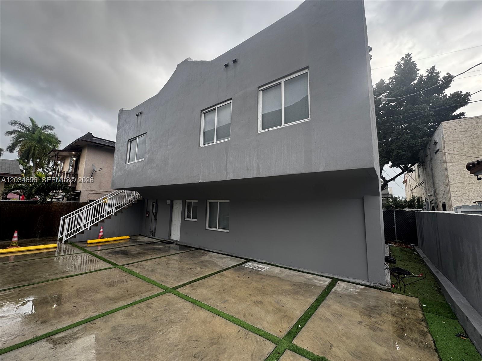 A two-story gray building features an exterior staircase and a paved parking area — 1684 SW 10th St, Miami FL 33135, MIAMI, FL