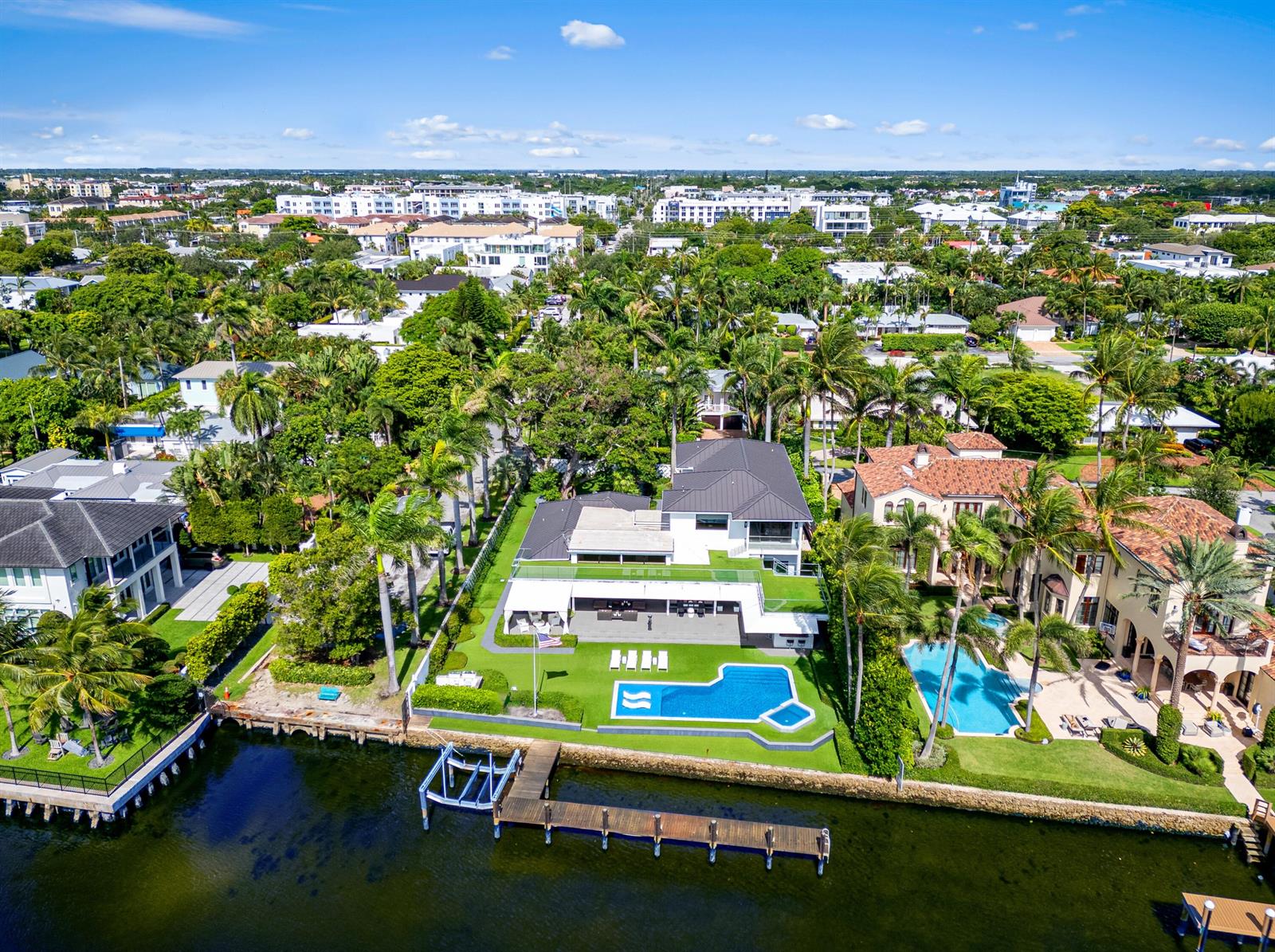 An aerial view of a waterfront house with a swimming pool and private dock — 201 Palm Trail, Delray Beach FL 33483, DELRAY BEACH, FL