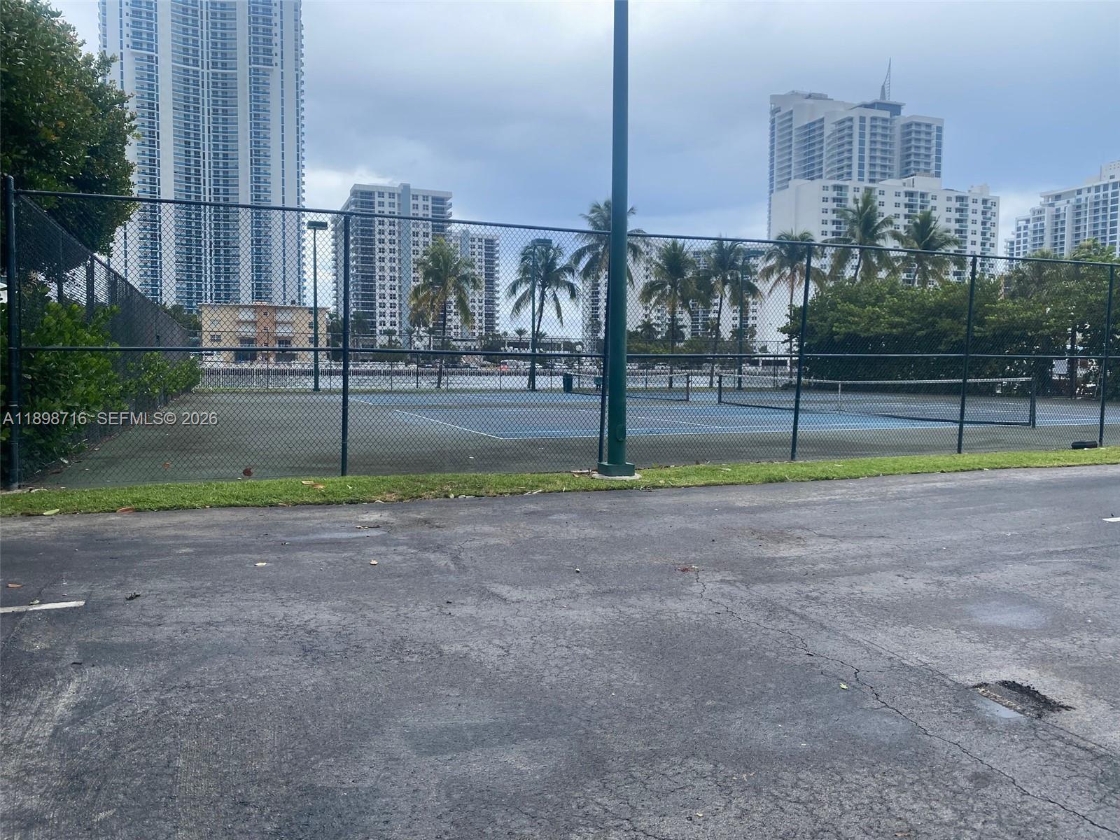 A lobby area features blue furniture, a circular coffee table, and a large abstract painting — 1000 Parkview Dr # 427, Hallandale Beach FL 33009, HALLANDALE BEACH, FL