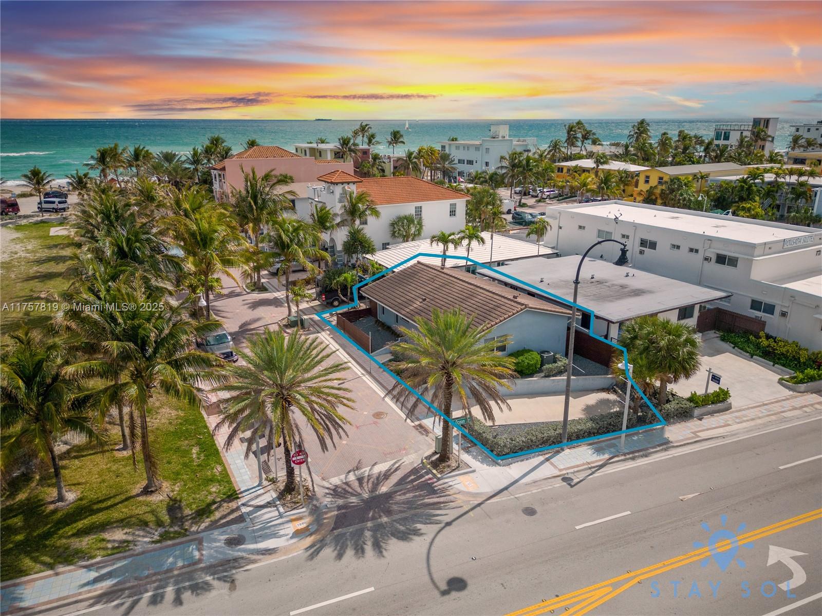 An aerial view shows a single-story house with a tiled roof near the ocean — 328 Missouri St, Hollywood FL 33019, HOLLYWOOD, FL