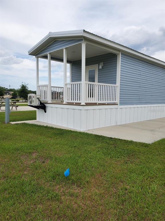 A small blue house with a front porch and an exterior air conditioning unit — 4345 NW 27TH PLACE, OCALA, FL