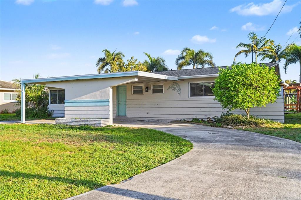 A single-story house with a carport, light-colored siding, and a concrete driveway — 468 GRENIER DRIVE, NORTH FORT MYERS, FL