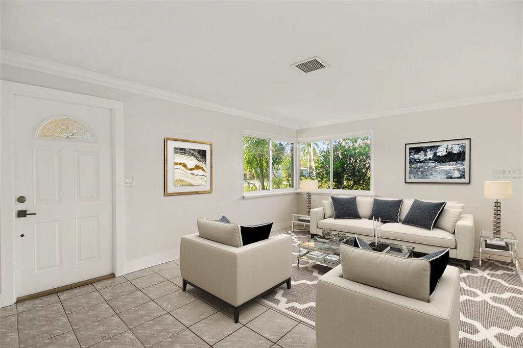 A living room with light tile floors, white walls, a sofa, and two armchairs — 468 GRENIER DRIVE, NORTH FORT MYERS, FL