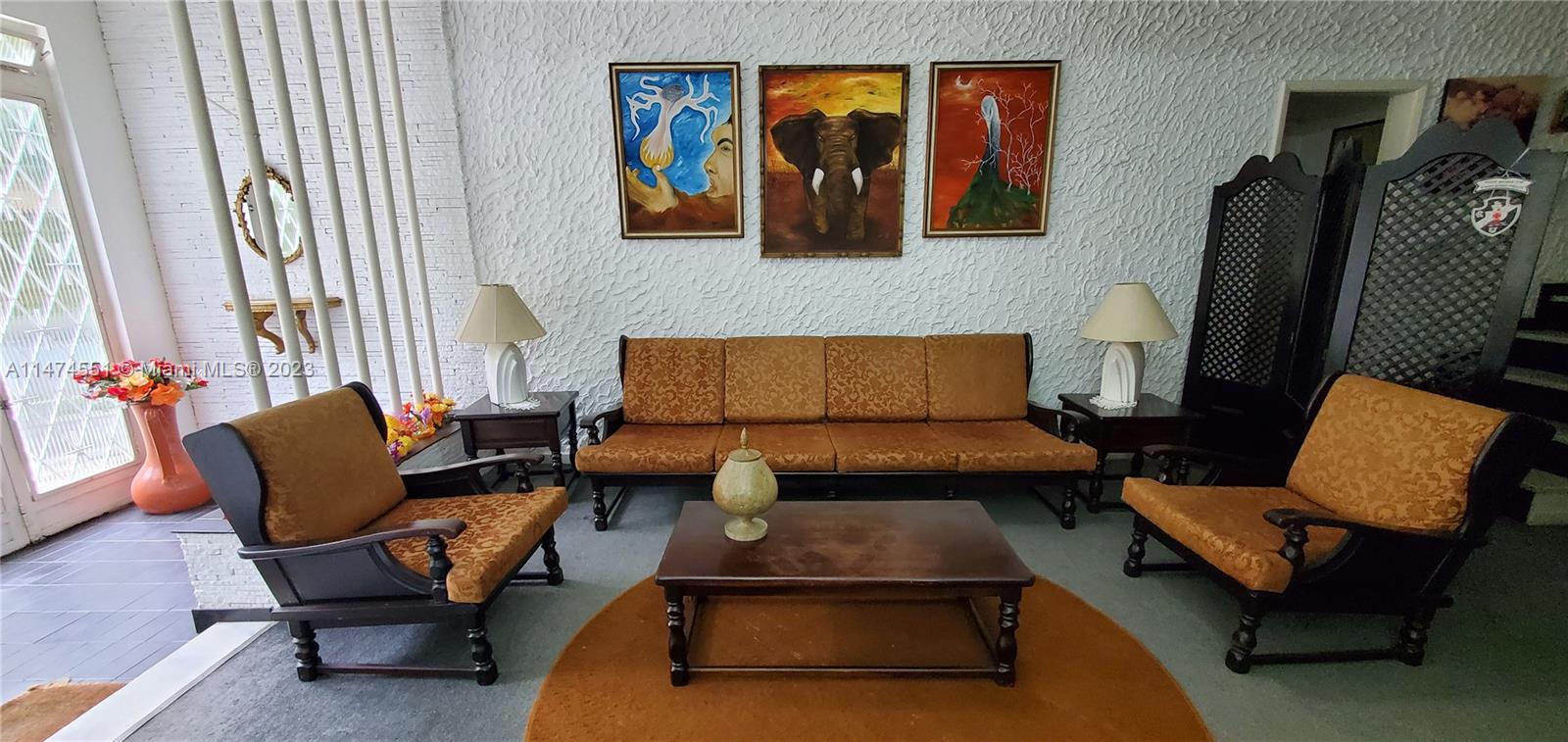 A living room features a sofa, two armchairs, a coffee table, and three wall paintings — 311 MOSELA, FL 25675-481, FL