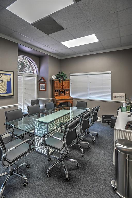 A conference room features a glass-topped table, gray office chairs, and a wooden hutch — 705 DOUGLAS AVENUE, ALTAMONTE SPRINGS, FL