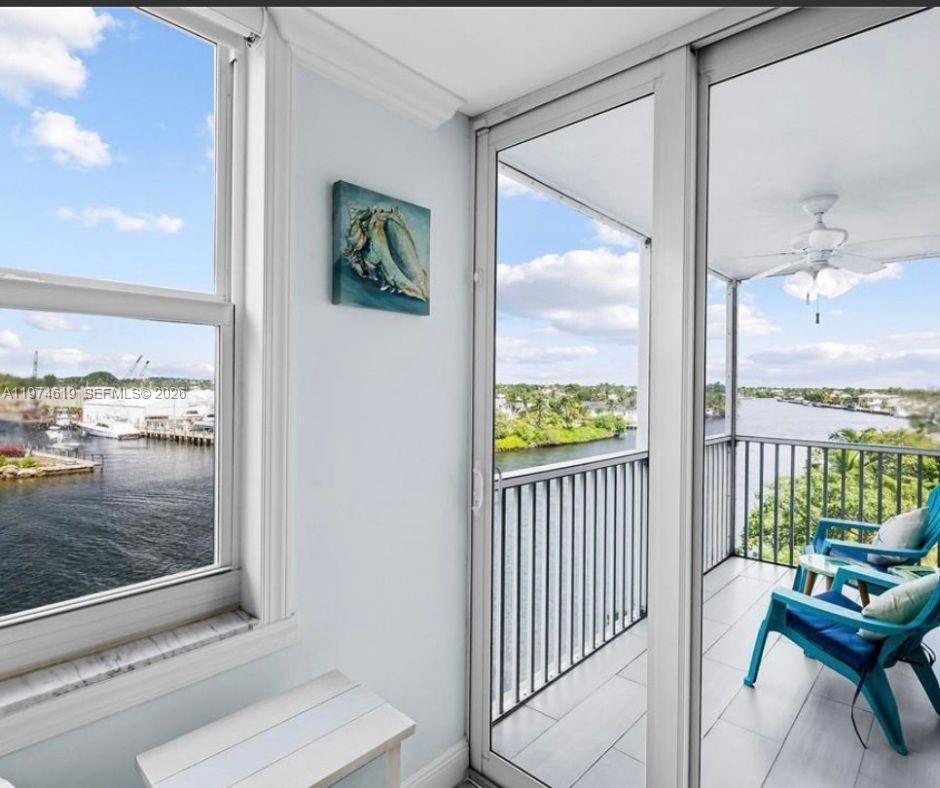 A view from an interior room looking out onto a balcony overlooking a waterway — 1505 N Riverside Dr # 505, Pompano Beach FL 33062, POMPANO BEACH, FL