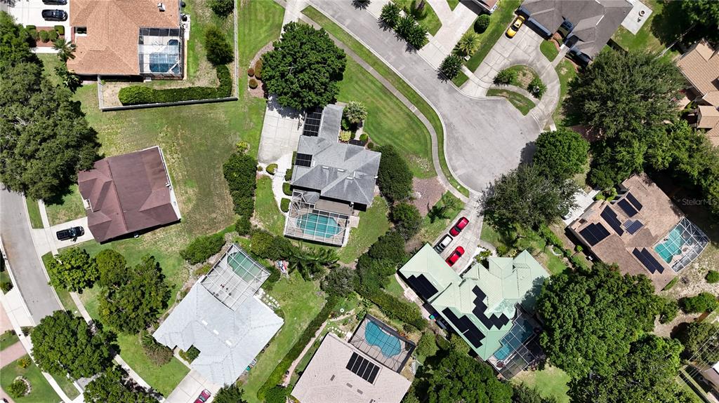 An aerial view shows several suburban houses with swimming pools and driveways in a neighborhood — 10221 LUNDY COURT, ORLANDO, FL