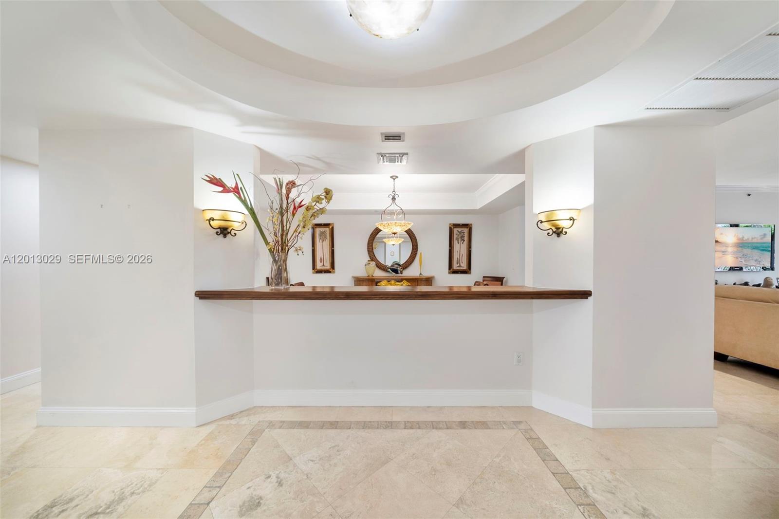 A wet bar with a wooden countertop sits beneath a recessed ceiling in a room — 791 Crandon Blvd # 404, Key Biscayne FL 33149, KEY BISCAYNE, FL