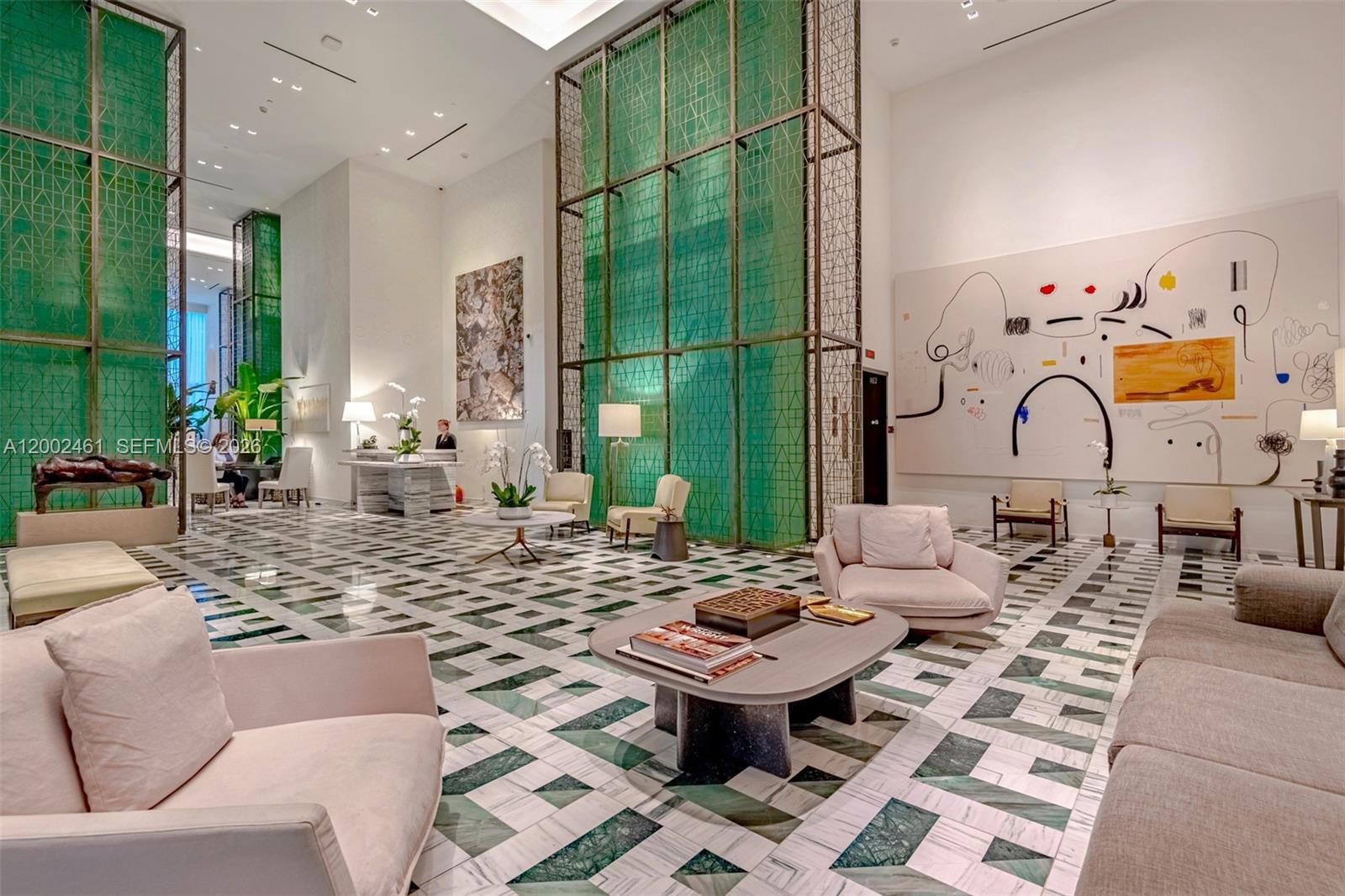 A spacious hotel lobby features high ceilings, green glass partitions, and patterned marble floors — 801 S Miami Ave # 4608, Miami FL 33130, MIAMI, FL