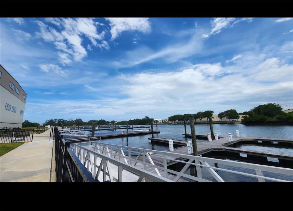 A view of a marina with boat slips and docks under a cloudy blue sky — 21 DEL PALMA DRIVE, PALM COAST, FL