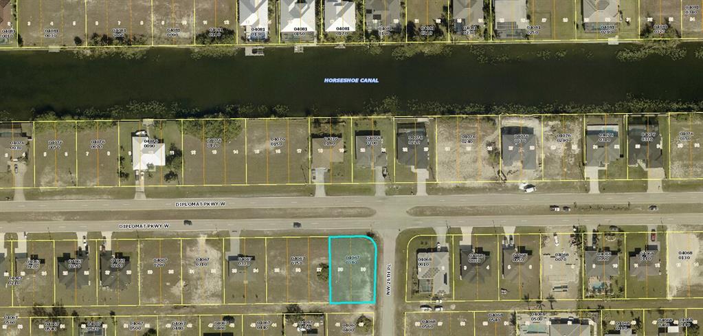 An aerial map view shows a vacant residential lot highlighted in blue along a street — 2614 DIPLOMAT PARKWAY W, CAPE CORAL, FL