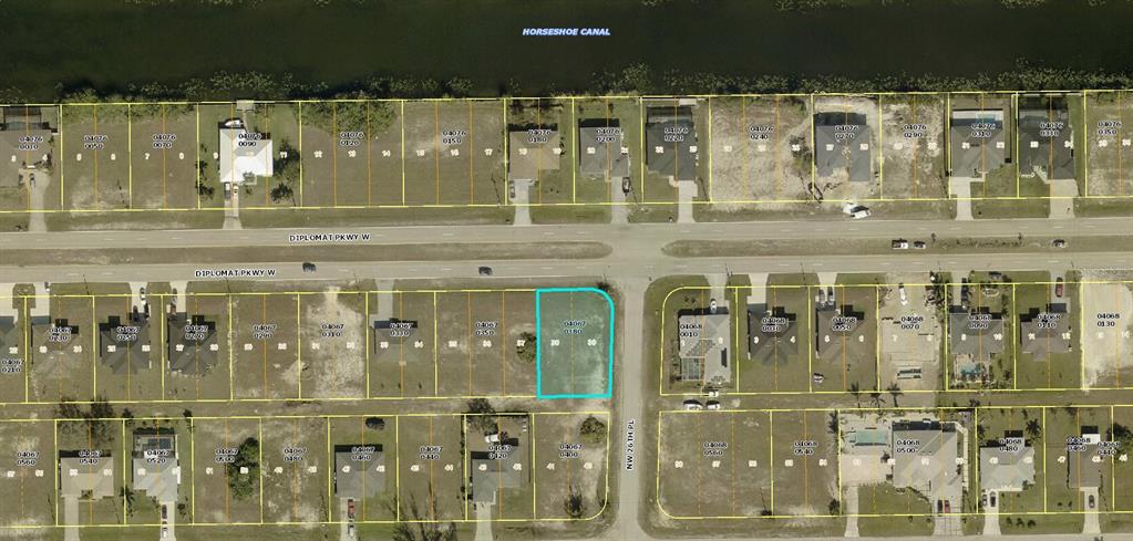 This is an aerial map view of a vacant residential lot highlighted in blue — 2614 DIPLOMAT PARKWAY W, CAPE CORAL, FL