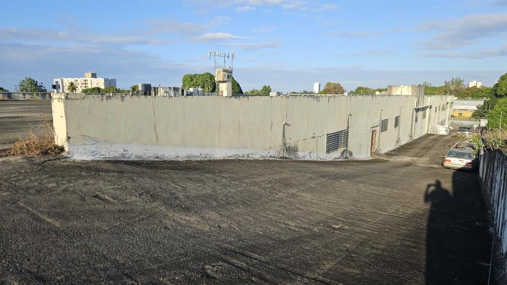 An exterior view of a large, flat-roofed building with a paved ramp and parking area — Ramon B. Lopez GAZTAMBIDE ST., SAN JUAN, PR